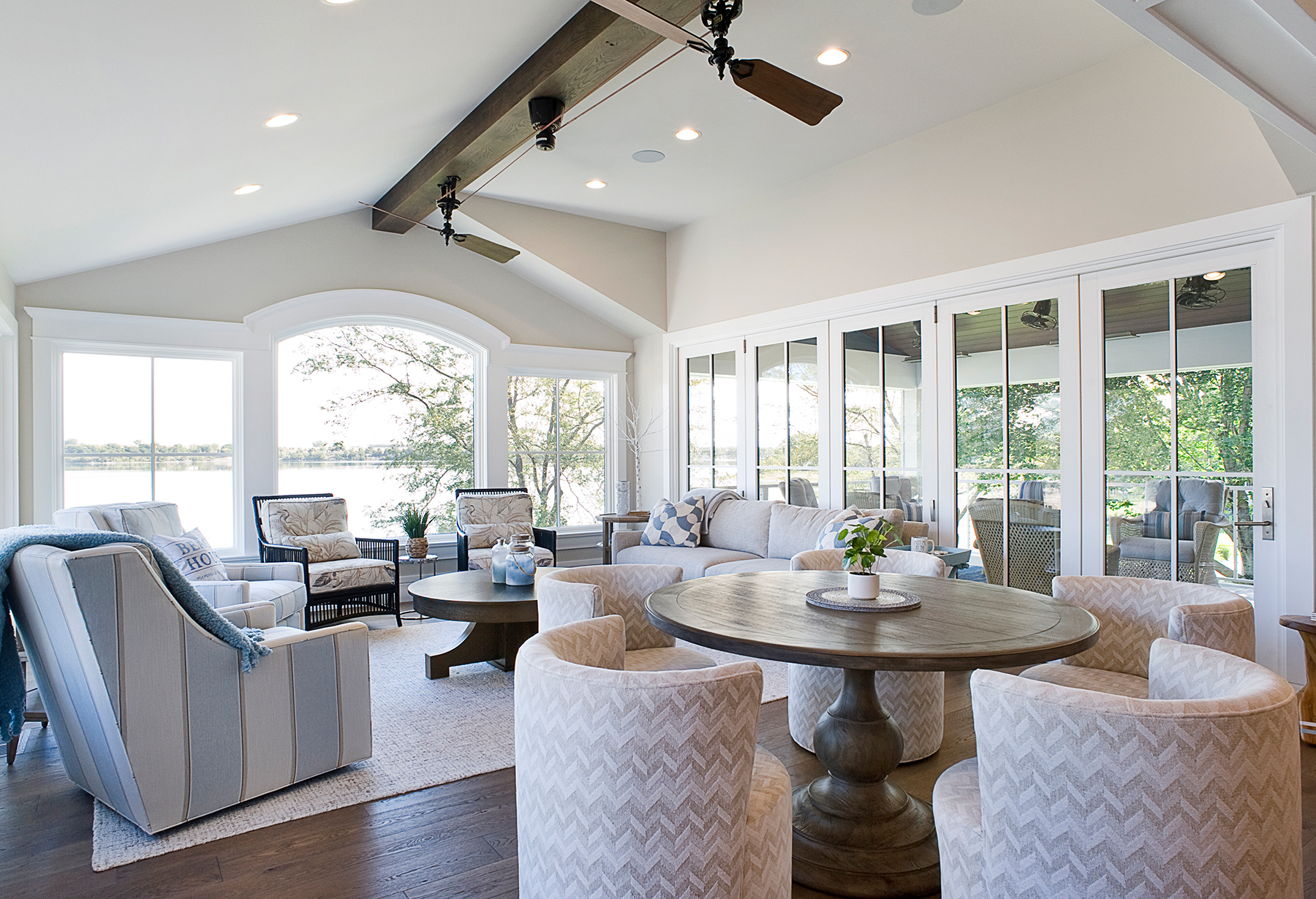 coastal modern home with wall of windows showing lake