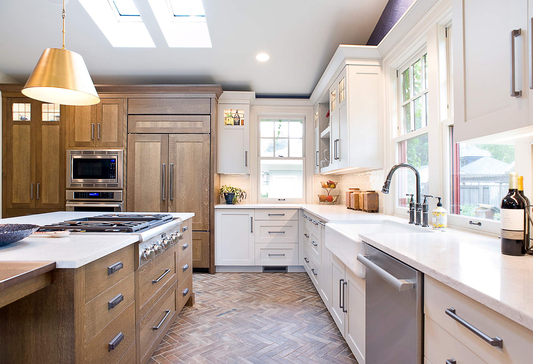 kitchen with two toned cabinetry, wooden cabinets and white cabinets