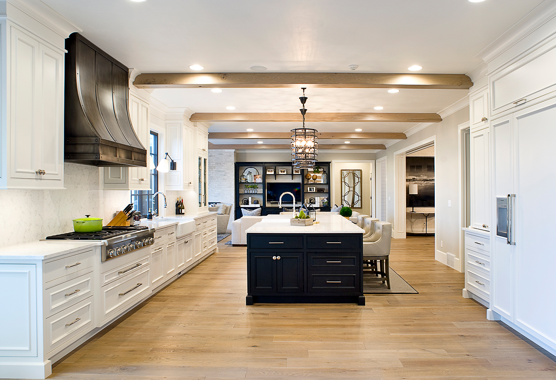 farmhouse style kitchen with white cabinets and a black island