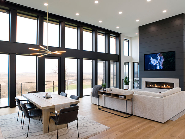 dining room and living room in front of a wall of large windows