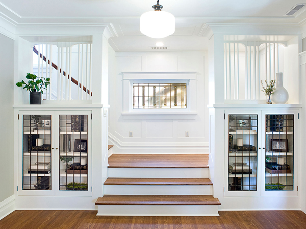 redesigned bookshelves with clear window doors leading up the stairs